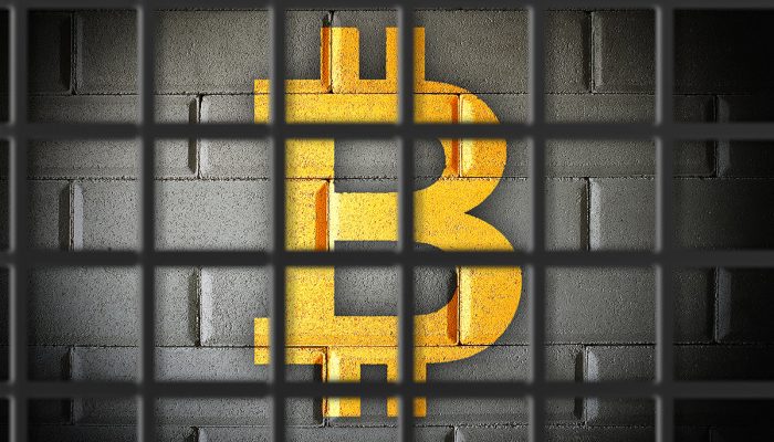 picture of a bitcoin locked behind prison bars